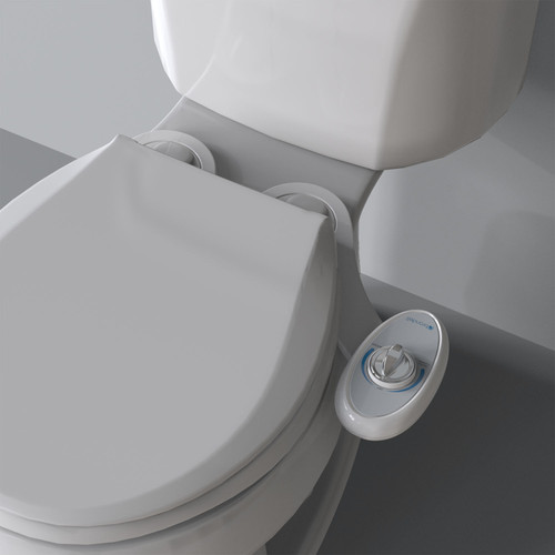 Brondell SouthSpa essential left-handed bidet attachment with single nozzle installed on the toilet  in front of a grey background