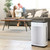 Brondell Pro air purifier in  the living room corner in front of a mom and daughter playing in the back