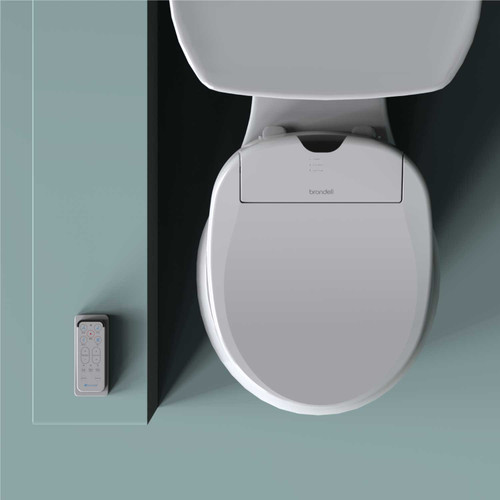 Brondell Swash 1000 S1000 advanced bidet toilet seat installed on the toilet with the wireless remote control on the side in a sage green bathroom