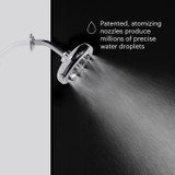 Side view of the Nebia Corre Four-Funtion Fixed Showerhead Chrome spraying water with a gray and black background - Patented, atomizing nozzles produce millions of precise water droplets.