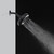 Side view of the Nebia Corre Four-Funtion Fixed Showerhead Matte Black spraying water with a gray and black background