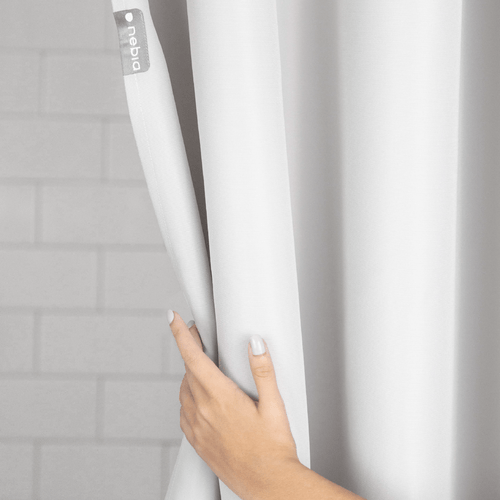 Nebia Shower Curtain in a gray bathroom with a hand opening the curtain