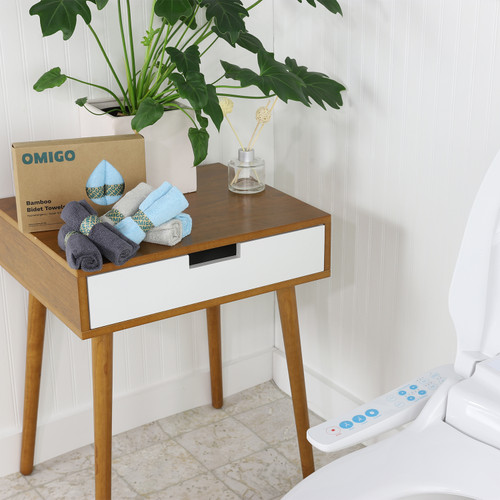 Omigo Bamboo Bidet Towels placed on side table with a plant accent